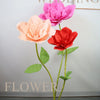 A vertical arrangement of pink and orange foam rose flowers on a white stand for wedding decor.