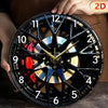 A close-up of a black and gold creative 2D tire wheel acrylic wall clock being held by a hand.