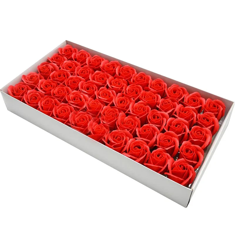 A rectangular box filled with numerous bright red artificial rose heads for decoration.