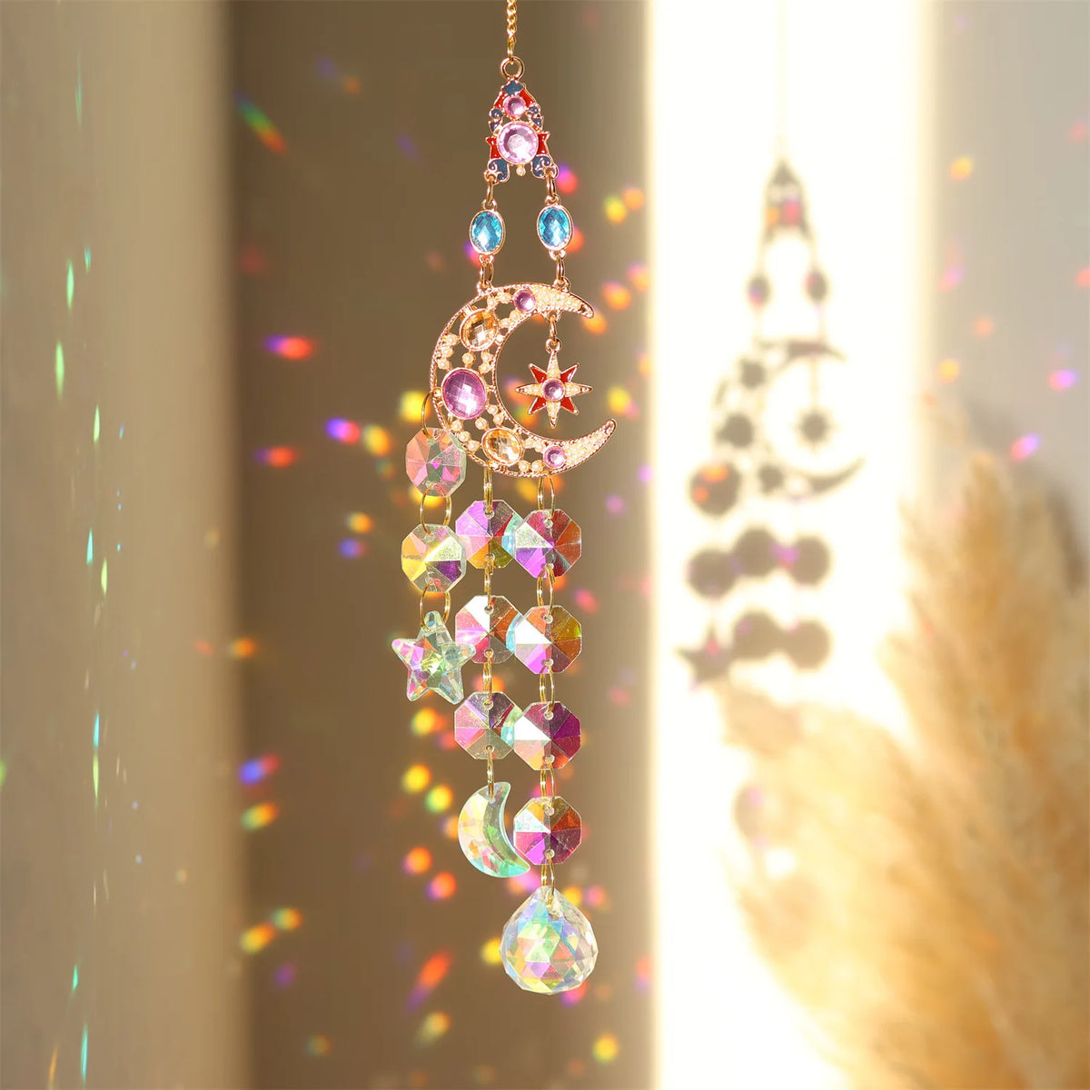 A hanging crystal sun catcher window pendant featuring various colored gemstone charms and a crescent moon design.