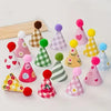 A collection of colorful mini party hat cake toppers in various shades of pink, yellow, green, and blue.