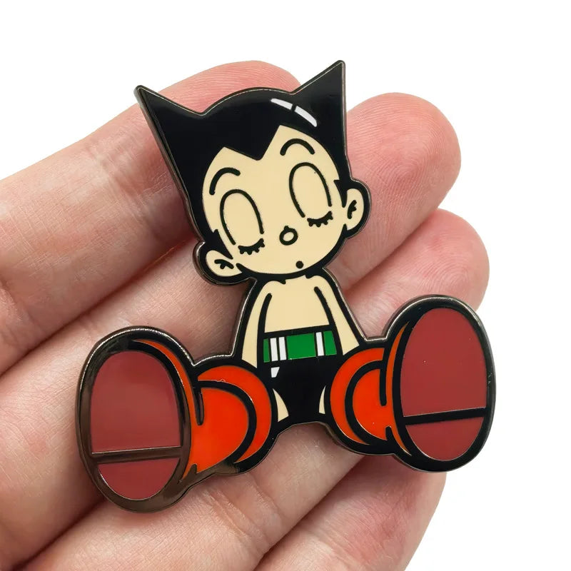 An enamel pin featuring a cartoon cat character with large eyes and a black and white design.