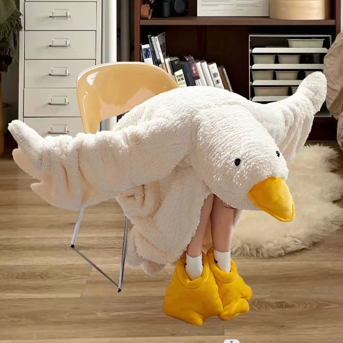 A white cartoon goose lounge robe with a yellow hood and yellow slippers hanging on a hanger.