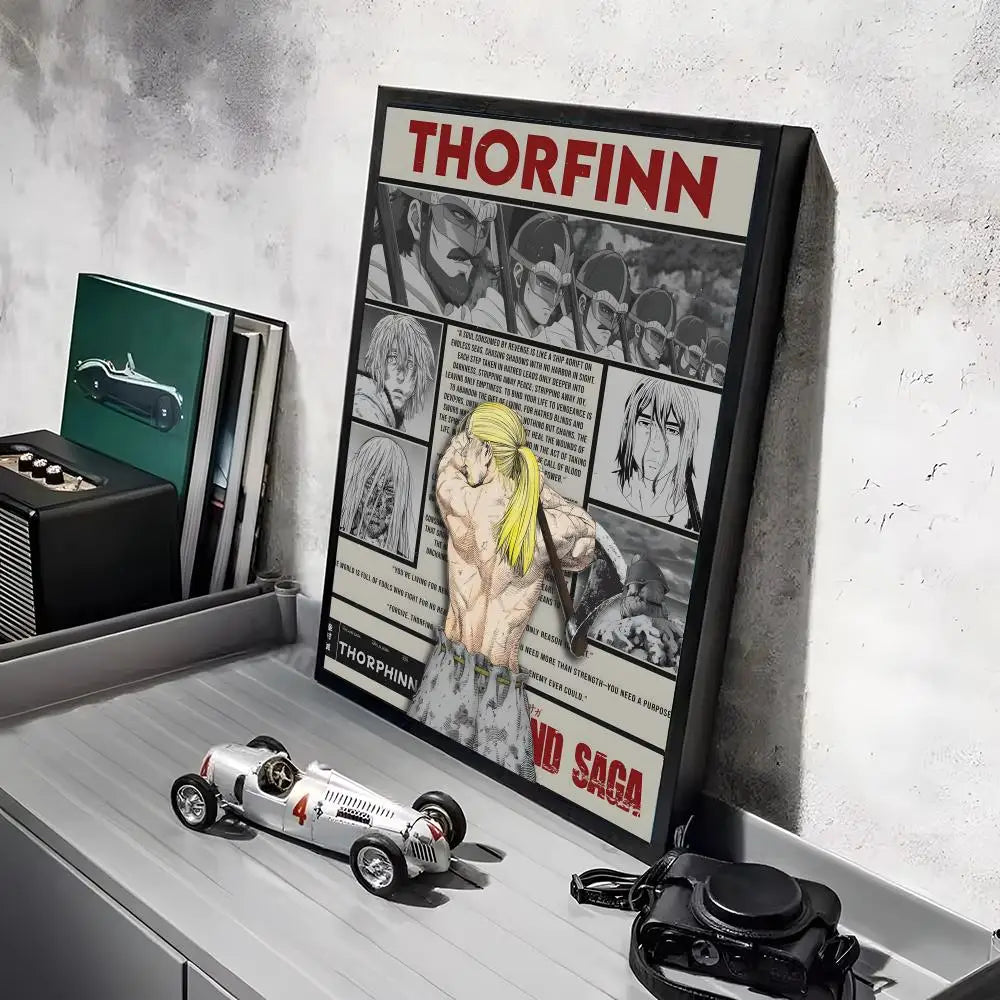 A framed poster of the Vinland Saga anime featuring characters and text on a gray shelf.
