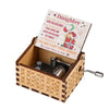 A vintage hand-cranked wooden music box with a lid featuring text about a daughter and a gift from heaven.
