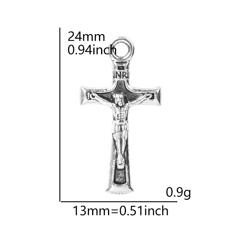A silver crucifix charm measuring 24mm long and weighing 0.9 grams.