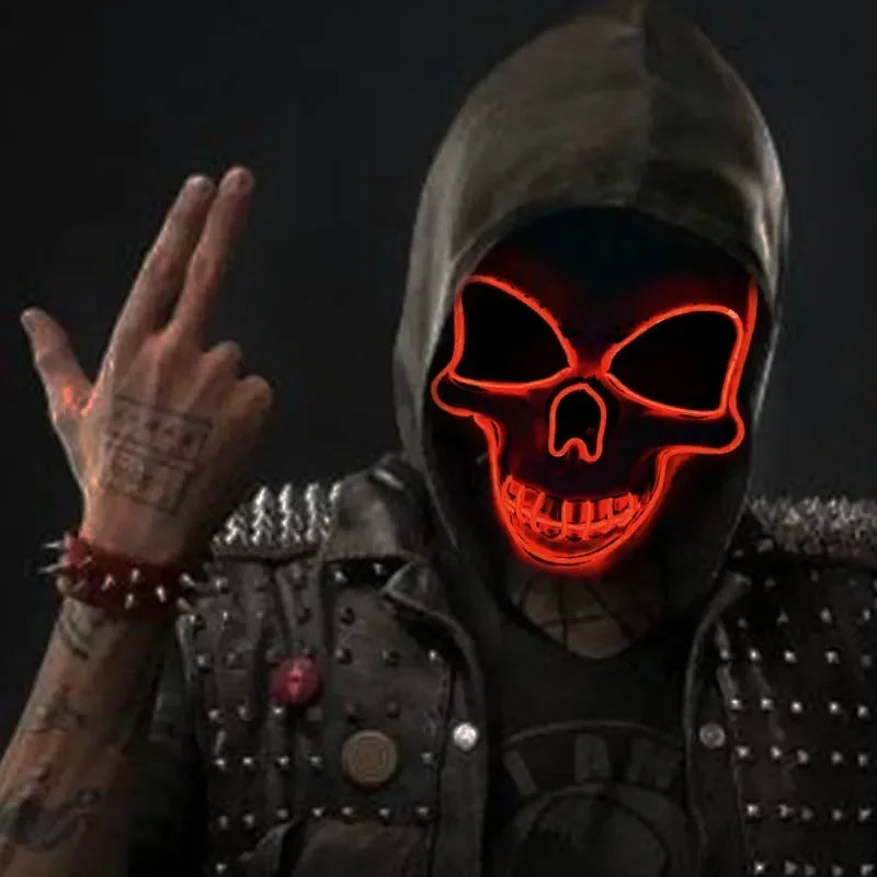 A person wearing a dark hooded outfit and an LED glow skull mask with red lighting.