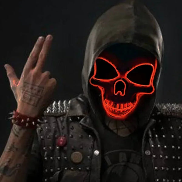 A person wearing a dark hooded outfit and an LED glow skull mask with red lighting.