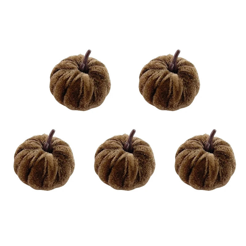 A set of five fuzzy brown foam pumpkins used for Halloween decoration.