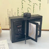 A black rotating flip photocard display frame is shown on a white surface.