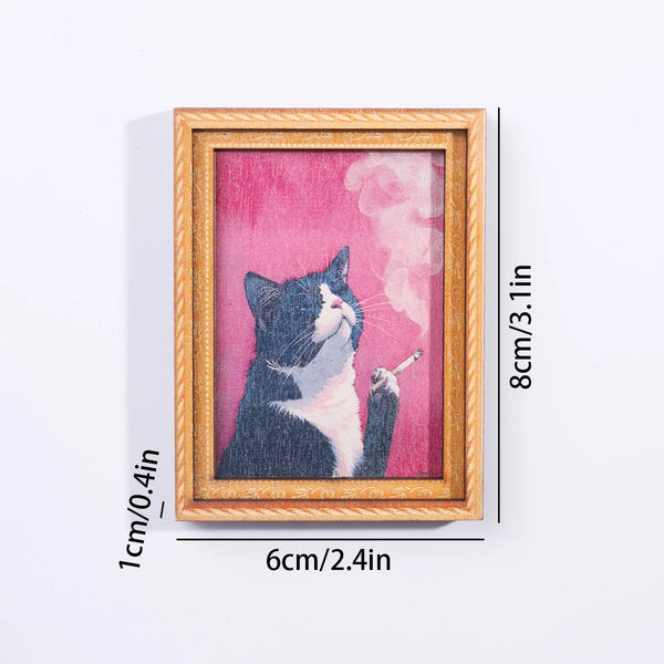 A framed artwork featuring a black and white cat silhouette against a pink background.
