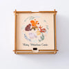 A wooden keepsake box for baby milestone cards featuring painted animals and greenery.