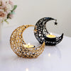 A gold crescent moon candle holder and a black crescent moon candle holder are displayed on a white surface.
