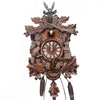 A vintage wooden cuckoo clock featuring intricate carvings and a round clock face.