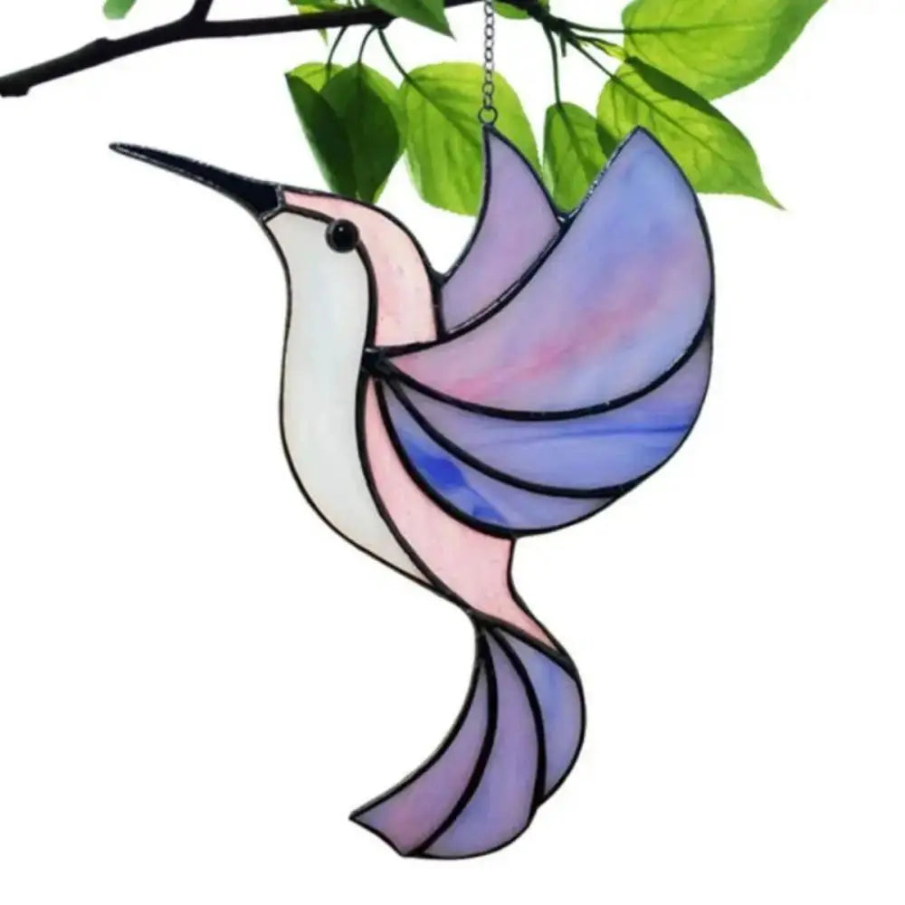 A colorful acrylic hummingbird suncatcher with iridescent pink and blue wings hanging from a branch.