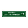 Green rectangular sign with white text that reads ASK ABOUT Custom Orders!