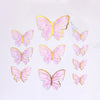 A collection of pink and gold butterfly cake toppers for parties and baking.