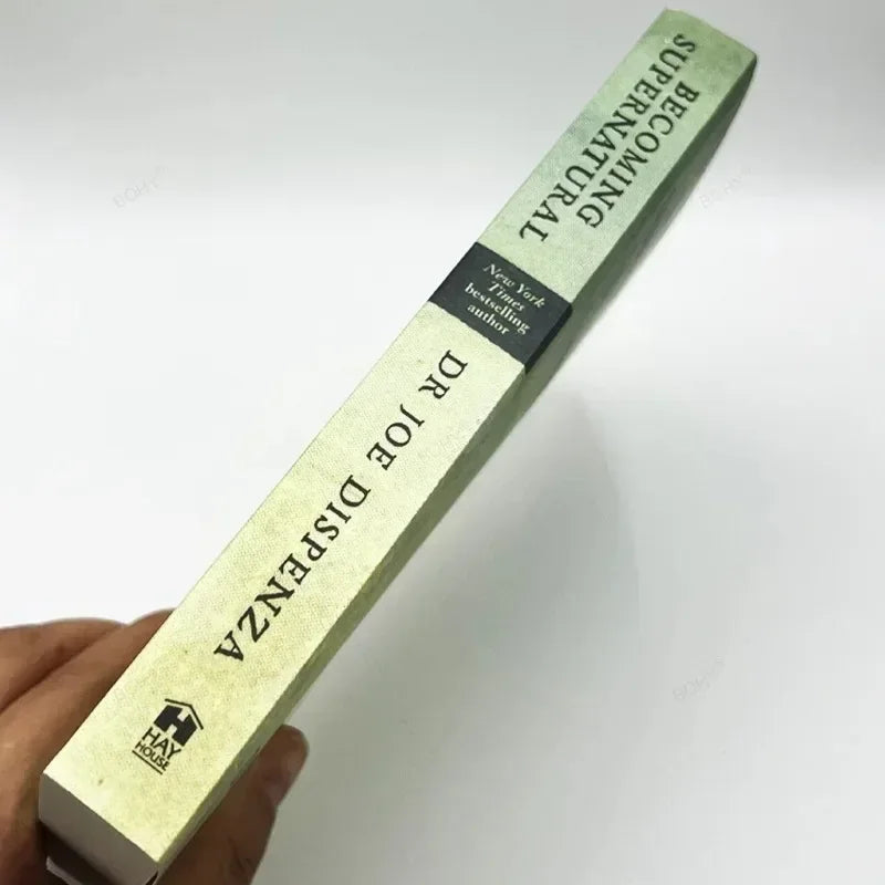 A close-up of a book titled Becoming Supernatural by Dr Joe Dispenza with text on the spine.