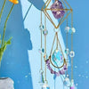 A hanging amethyst crystal suncatcher with golden accents, featuring various clear and purple beads.