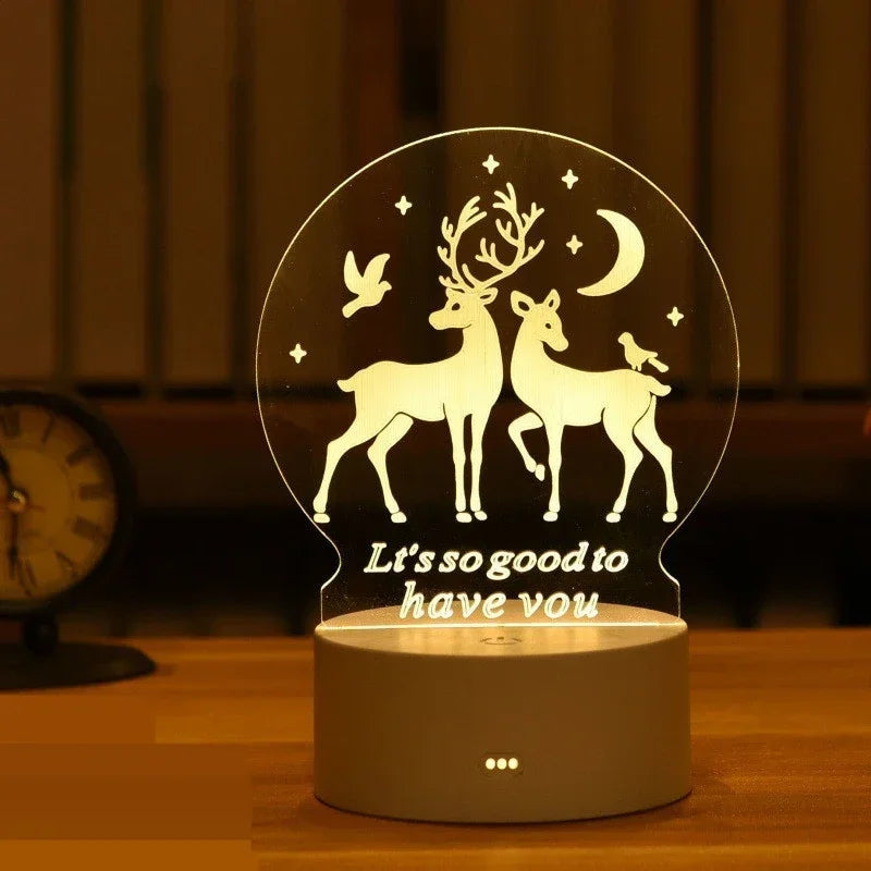 A clear acrylic night light featuring a silhouette of a deer with antlers and a silhouette of a dog, illuminated by small LED