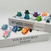 A set of six articulated baby dragon figurines in various colors displayed on a white box titled Between Lovers and Your Effo