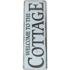 A vertical vintage metal sign with distressed white and gray paint that reads Welcome to the Cottage