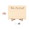 A light wood photo frame with cursive text 'love at first sight' and a ribbon, designed for pregnancy announcements.