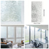 A close-up view of frosted glass window privacy film showing a textured, translucent white pattern.
