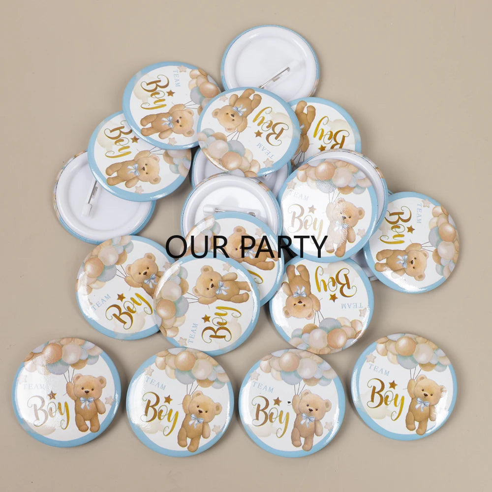 A collection of light blue and white pin badges featuring cartoon bears for a baby boy gender reveal or baby shower party.