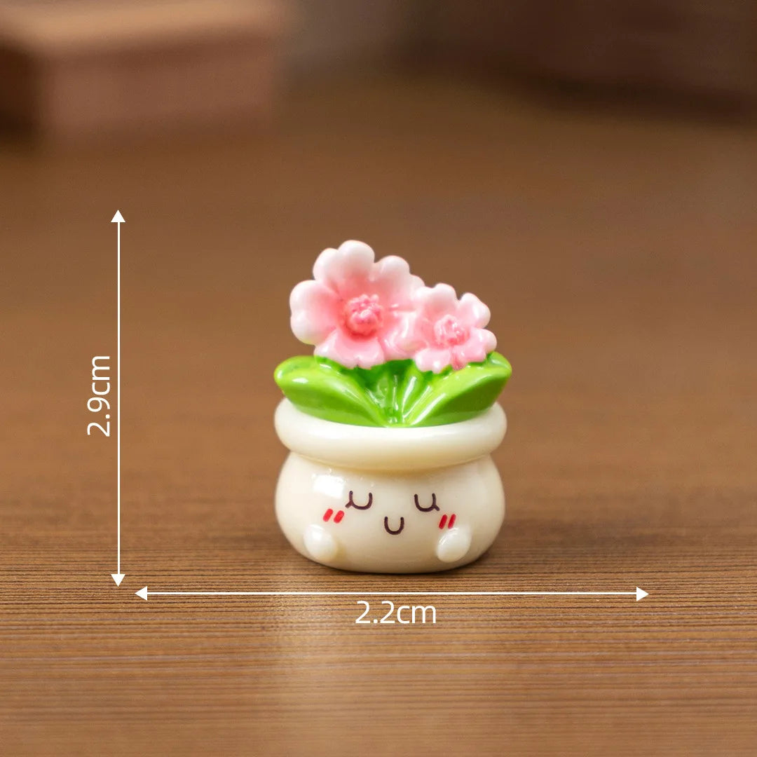 A small white ceramic potted rose charm with pink flowers and green leaves, measuring 2.9cm high.