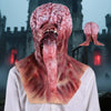A realistic latex mask resembling a grotesque alien face with a long tongue, displayed against a dark, gothic background.