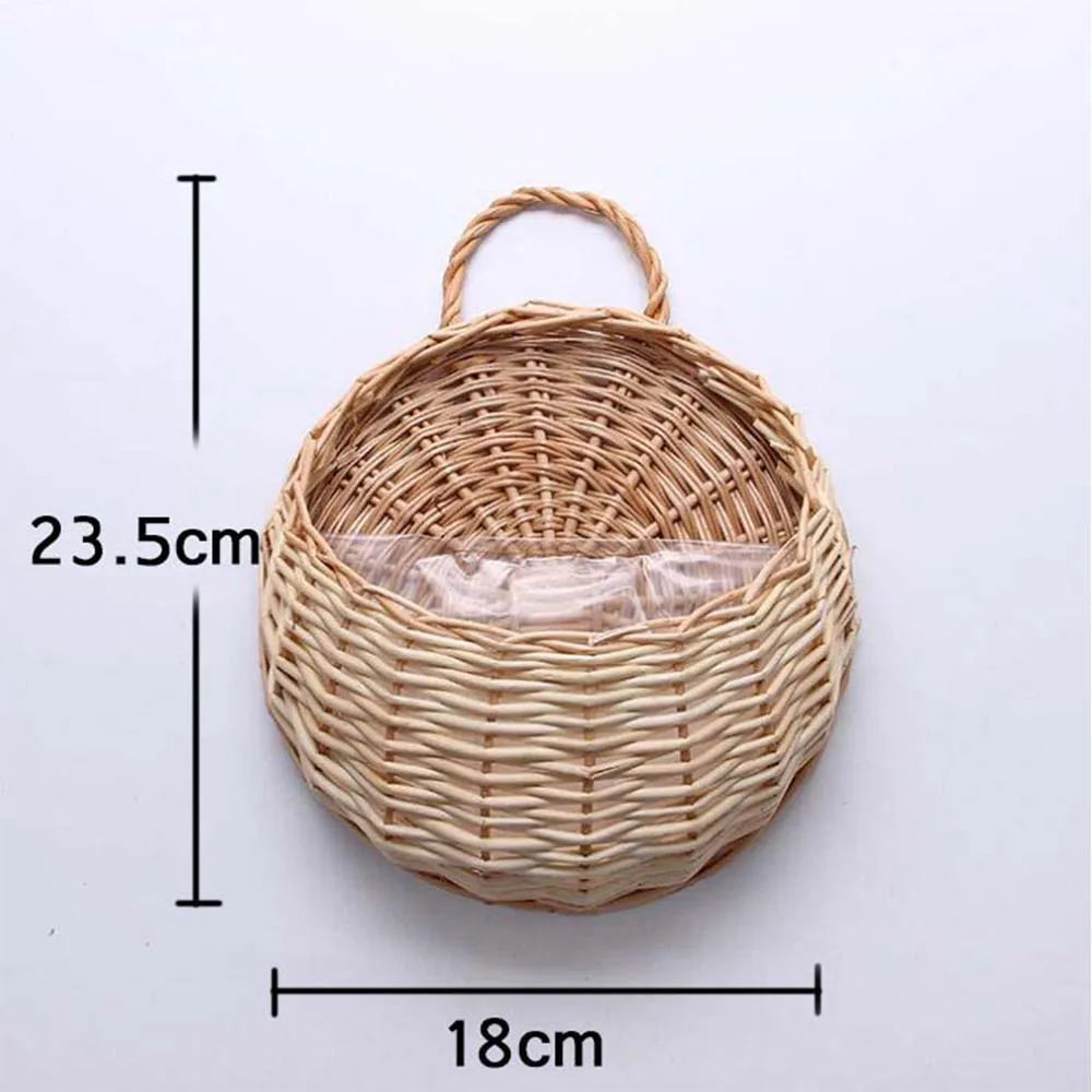 A woven natural fiber wall hanging basket with a handle, measuring 23.5cm by 18cm.