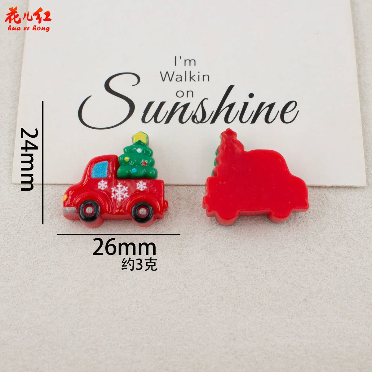 Two red resin cabochons shaped like a Christmas tree and a truck, used for DIY crafts.