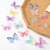 A collection of 10 colorful, embroidered butterfly patches in various shades of pink, purple, blue, and yellow arranged on a 