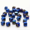 A collection of small, square-cut blue glass crystal beads for jewelry making