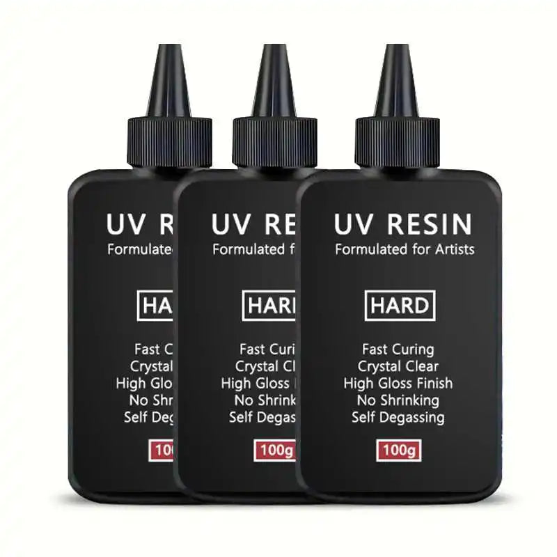 Five black dropper bottles of UV resin formulated for artists and jewelry making