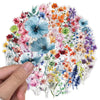 A hand holds a sheet of waterproof floral decal stickers featuring various colorful flowers on a transparent background.
