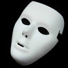 A white performance mask with a smooth, featureless face is shown against a black background.