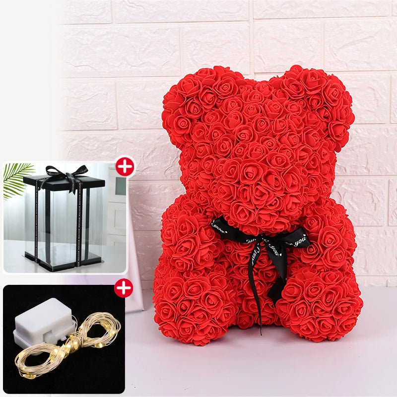 Peluche ours rose à poils, rouge, avec un ruban noir et une décoration lumineuse LED.
