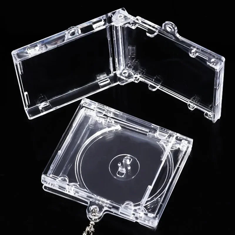 A clear plastic case containing a mini transparent CD keychain, shown open and closed.