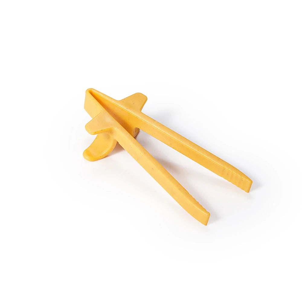 A pair of light yellow reusable wheat straw finger chopsticks shown against a white background.