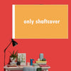 A blank orange banner mockup with the text only shaftcover displayed on a red wall.