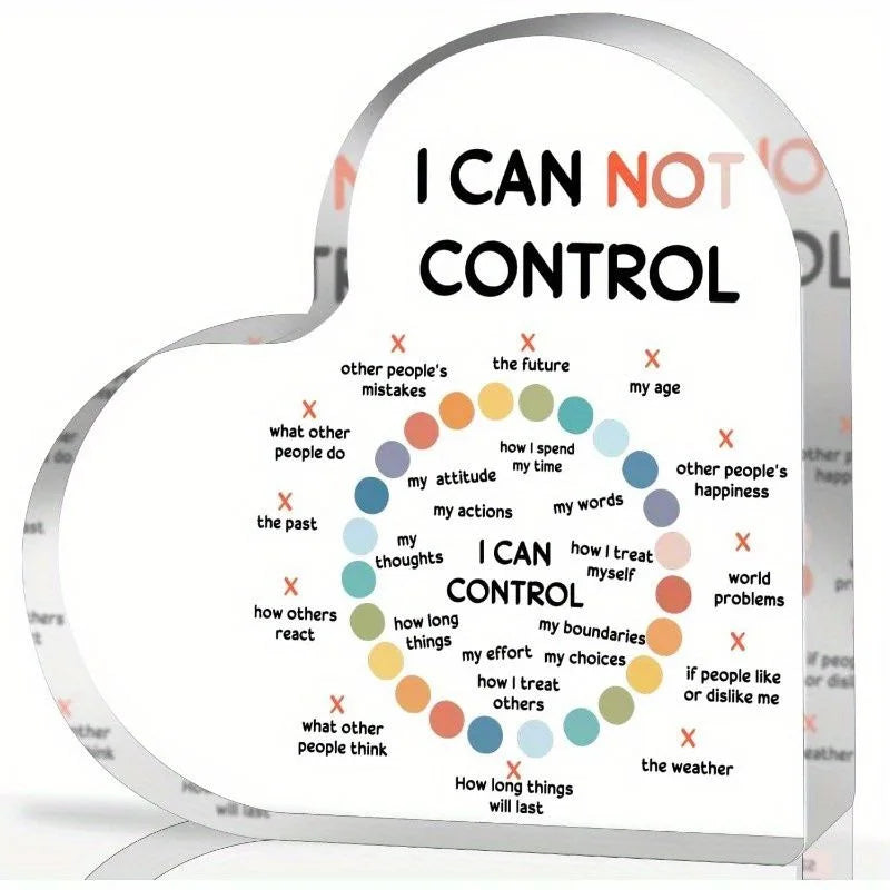 A heart-shaped acrylic sign displaying the phrase I CAN NOT CONTROL and I CAN CONTROL with various examples.