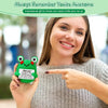 A woman holds an inspirational crochet frog ornament in her hand, smiling and pointing to it.