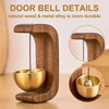 A wooden door bell featuring a brass bowl and hanging chime, highlighting durable natural wood and metal alloy.