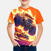 A young boy wearing an orange t-shirt with a full graphic print of the Monster Jam Grave Digger vehicle in yellow and purple 