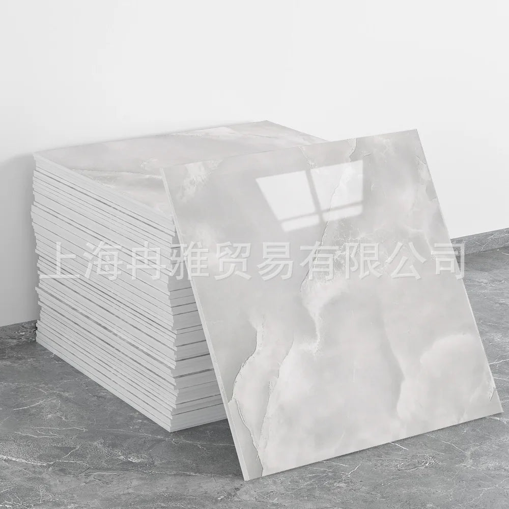 Stack of white faux marble 3D self-adhesive wall tiles or peel-and-stick wallpaper.