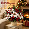 Christmas floral arrangement featuring red and white flowers and greenery displayed on a cabinet.