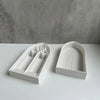White silicone molds shaped like church windows for resin and plaster crafting