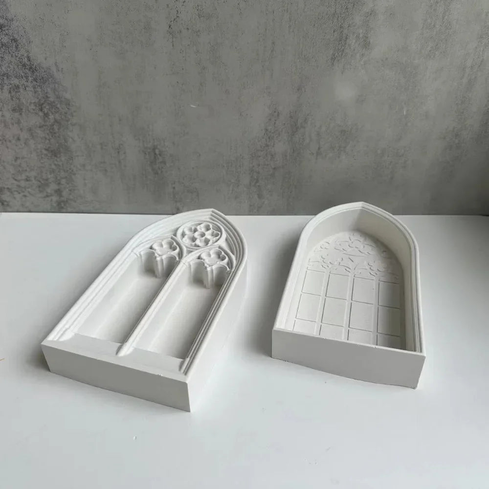 White silicone molds shaped like church windows for resin and plaster crafting